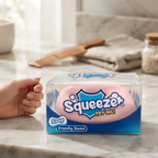 Squishy Jabón Crunchy rosado en su caja sobre un mesón de mármol